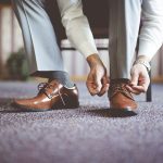 closeup shot of a male tying his shoes and getting ready for a business meeting